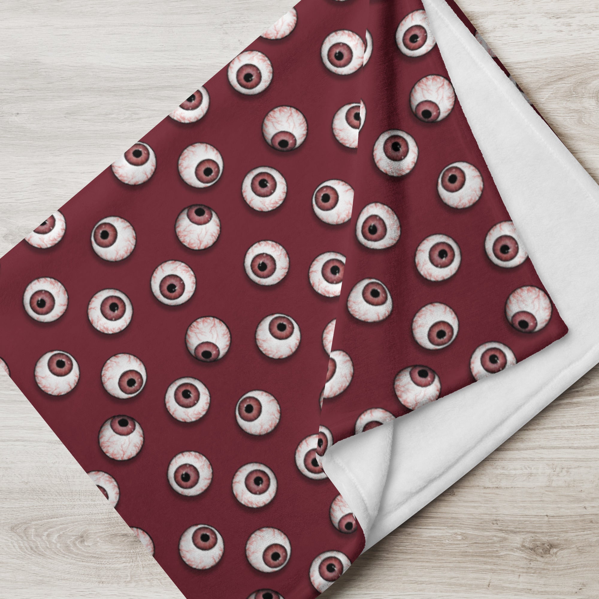 close up view of 60" x 80" eyeballs throw blanket in blood red